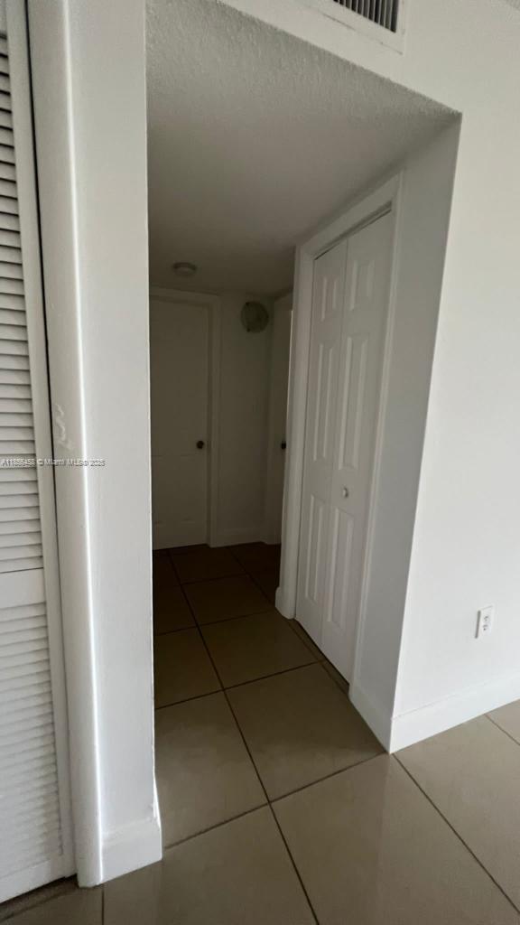 6950 Miami Gardens Drive, Unit 2508 Hialeah, FL 33015 - Photo 16 of 27 a view of a utility room with door
