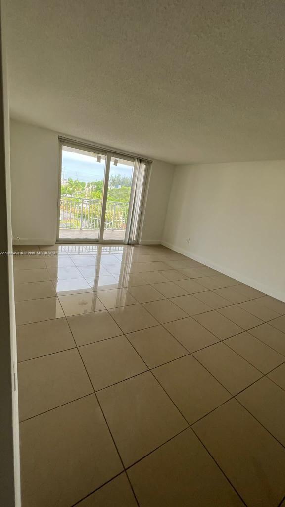 6950 Miami Gardens Drive, Unit 2508 Hialeah, FL 33015 - Photo 19 of 27 a view of an empty room with a window