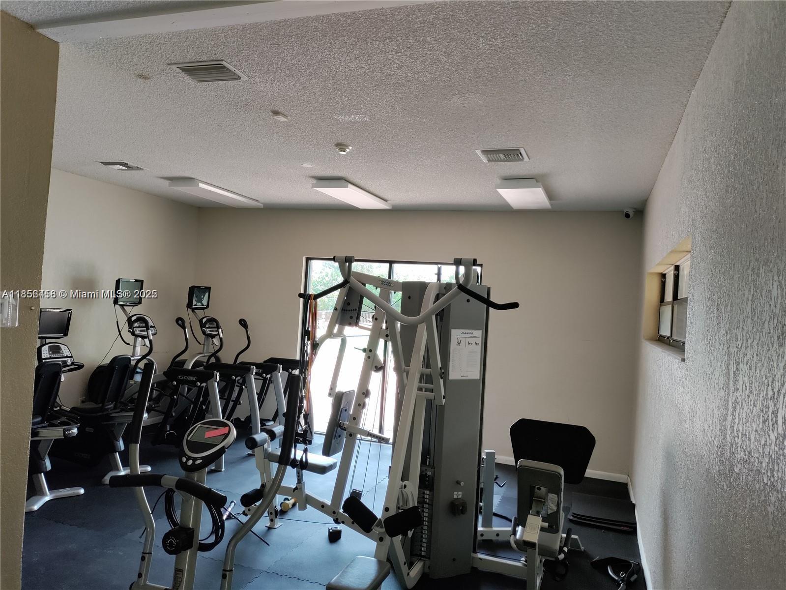6950 Miami Gardens Drive, Unit 2508 Hialeah, FL 33015 - Photo 27 of 27 a view of a room with gym equipment