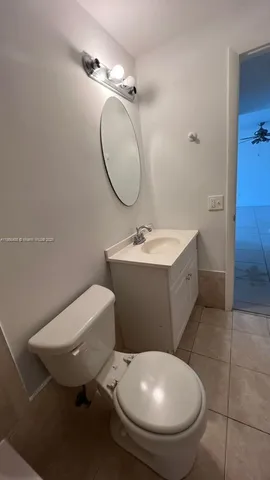a bathroom with a sink vanity and a mirror