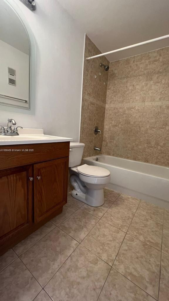 6950 Miami Gardens Drive, Unit 2508 Hialeah, FL 33015 - Photo 6 of 27 a bathroom with a sink a toilet a mirror and shower