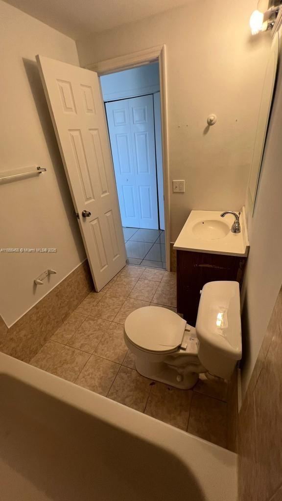 6950 Miami Gardens Drive, Unit 2508 Hialeah, FL 33015 - Photo 8 of 27 a bathroom with a sink a toilet and mirror