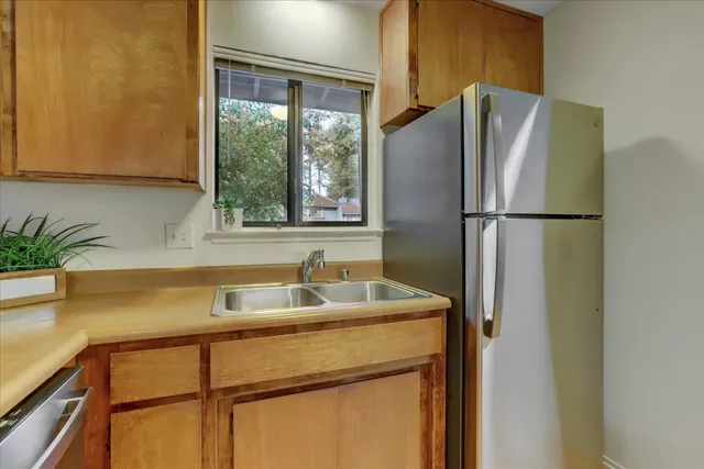 a view of an empty room with a fireplace and a window