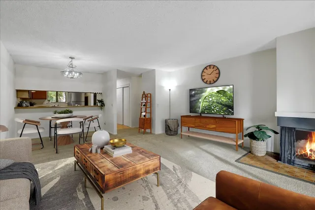 a living room with furniture a flat screen tv and a window