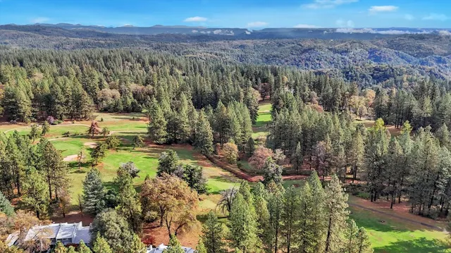 a view of a city from a balcony with outdoor seating