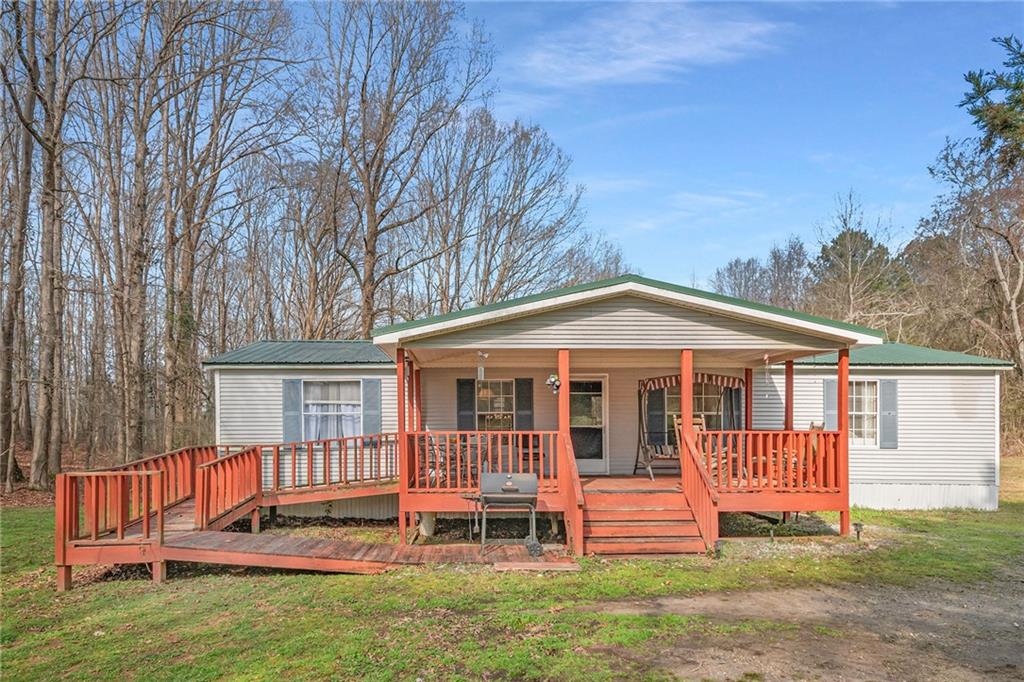 562 Swann Road Jefferson, GA 30549 - Photo 1 of 1 a view of a house with a yard and deck