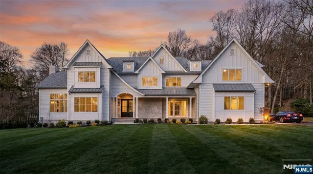 a front view of a house with a garden and yard