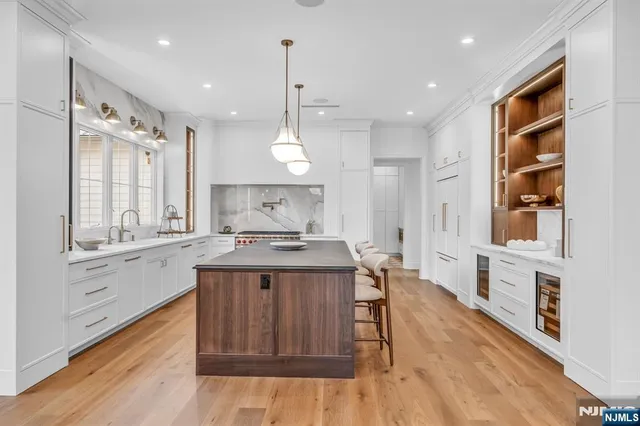 a spacious bathroom with a double vanity sink a mirror and a bathtub