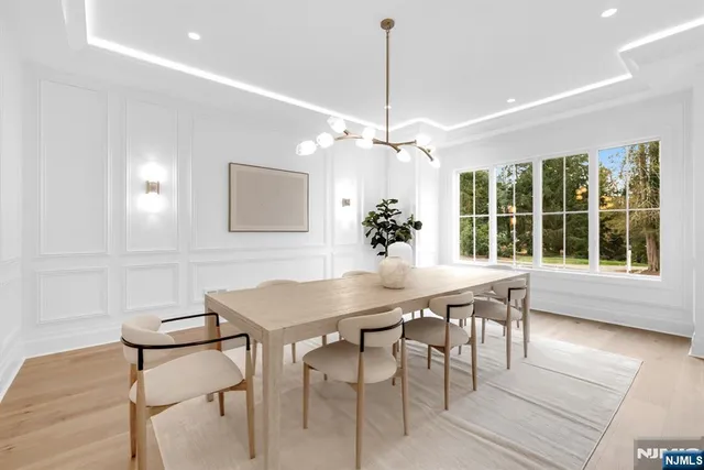a living room with furniture fireplace and a large window