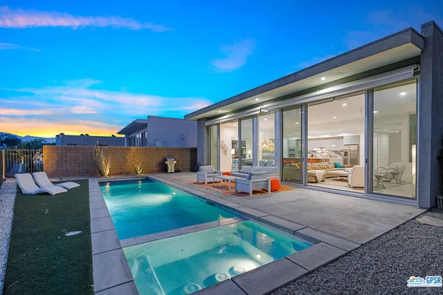 a view of a house with backyard porch and sitting area