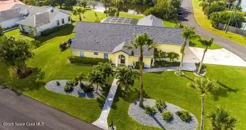 an aerial view of house with a yard