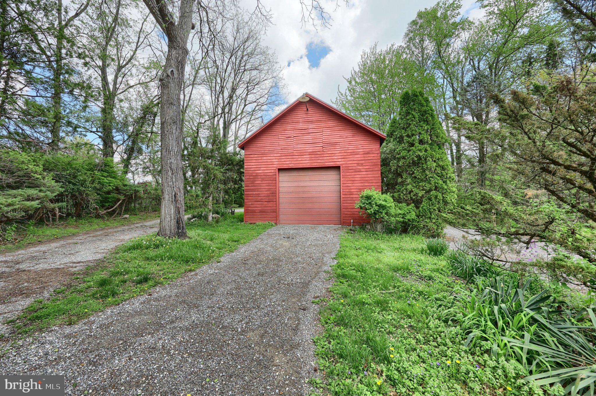 1974 Yingling Drive Spring Grove, PA 17362 - Photo 10 of 69 Charming red barn amidst lush greenery.
