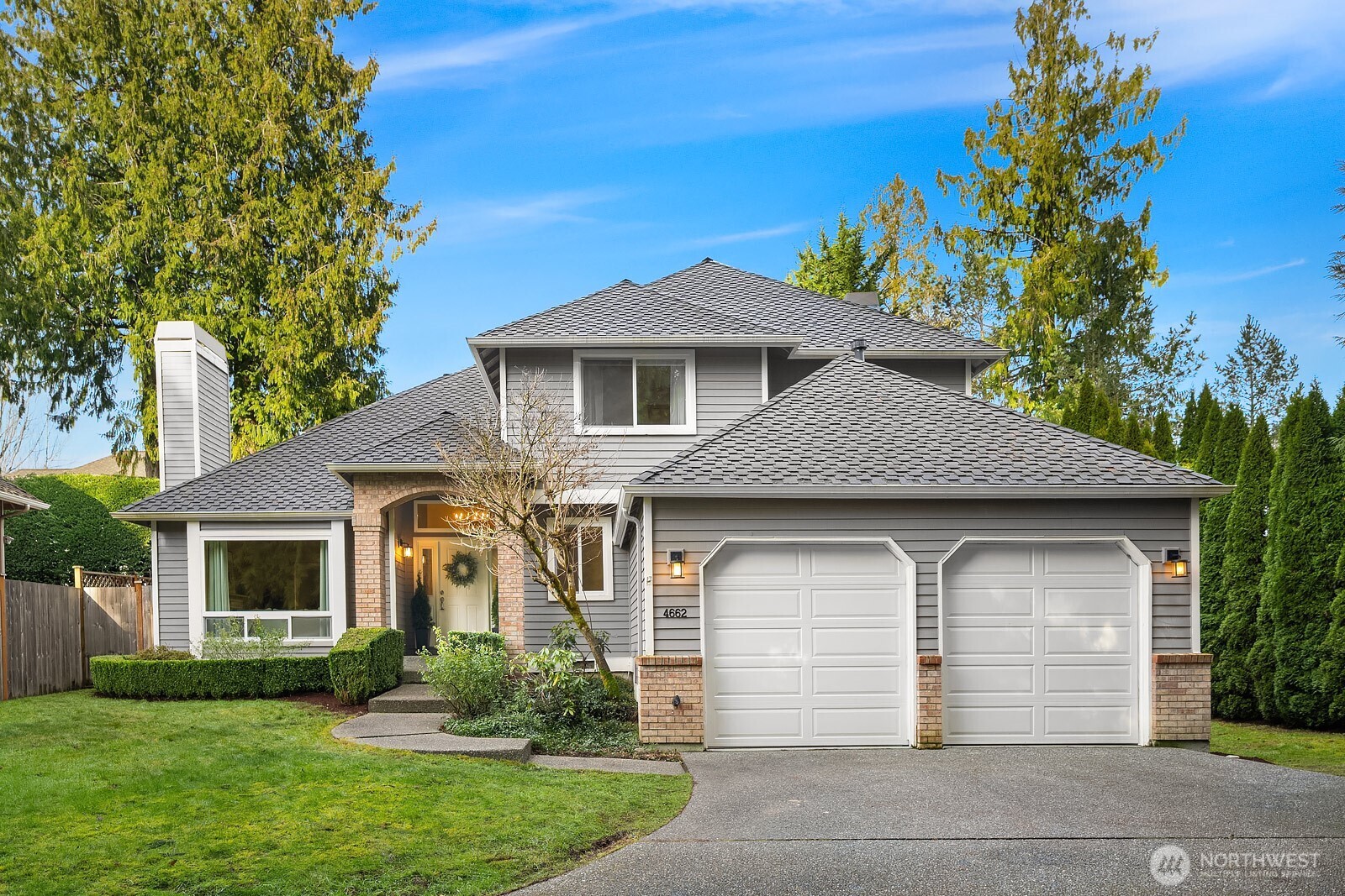 a front view of a house with a garden