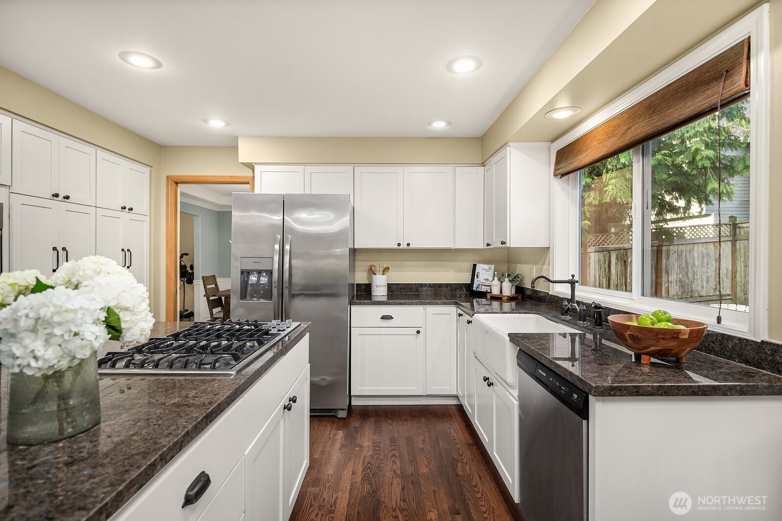 4662 244th Place Southeast Issaquah, WA 98029 - Photo 14 of 40 a kitchen with stainless steel appliances granite countertop a sink stove and refrigerator