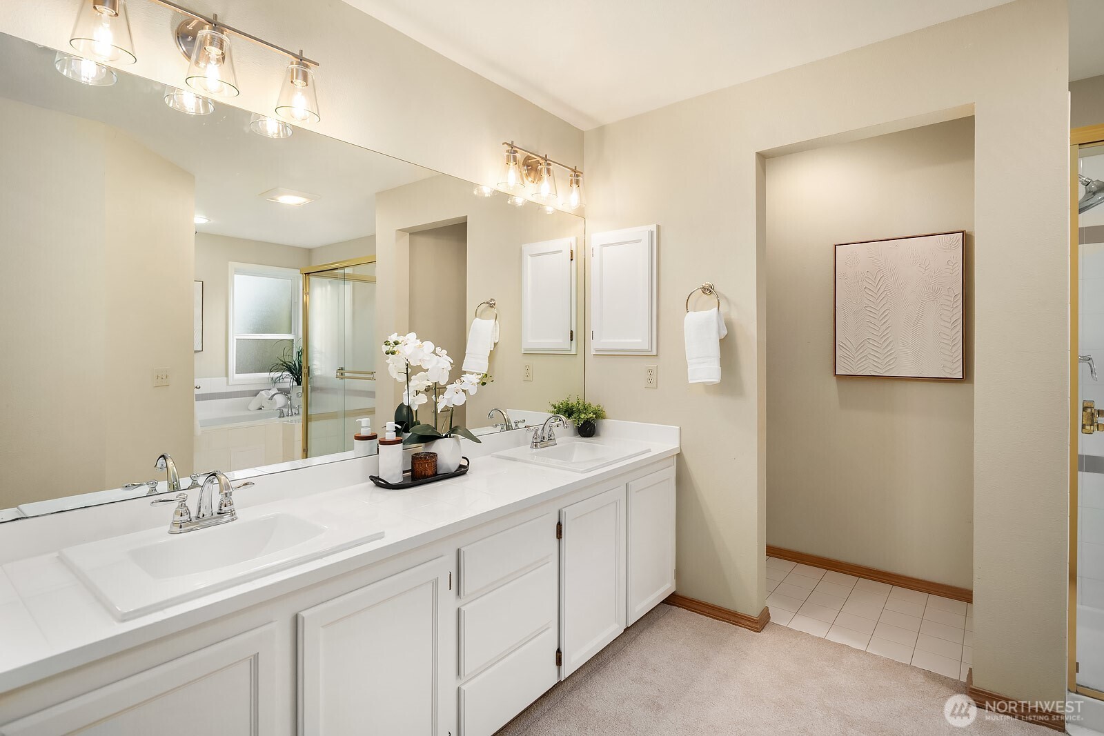 4662 244th Place Southeast Issaquah, WA 98029 - Photo 23 of 40 a bathroom with a double vanity sink and mirror