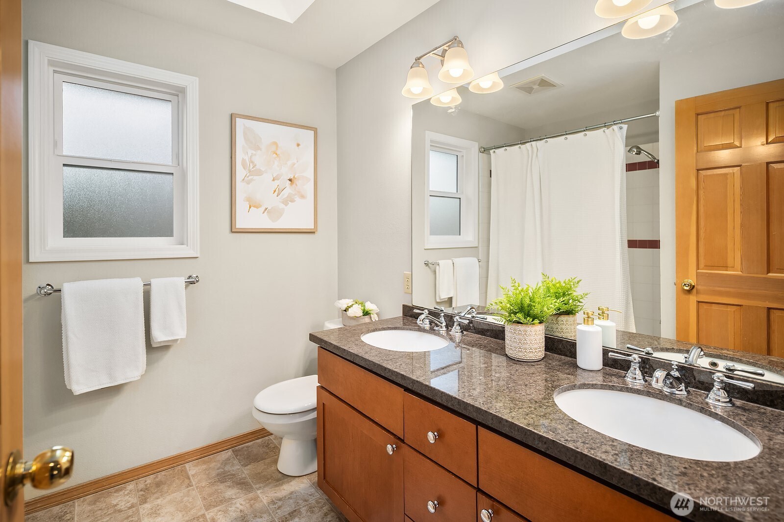 4662 244th Place Southeast Issaquah, WA 98029 - Photo 28 of 40 a bathroom with a granite countertop sink toilet a large mirror and shower