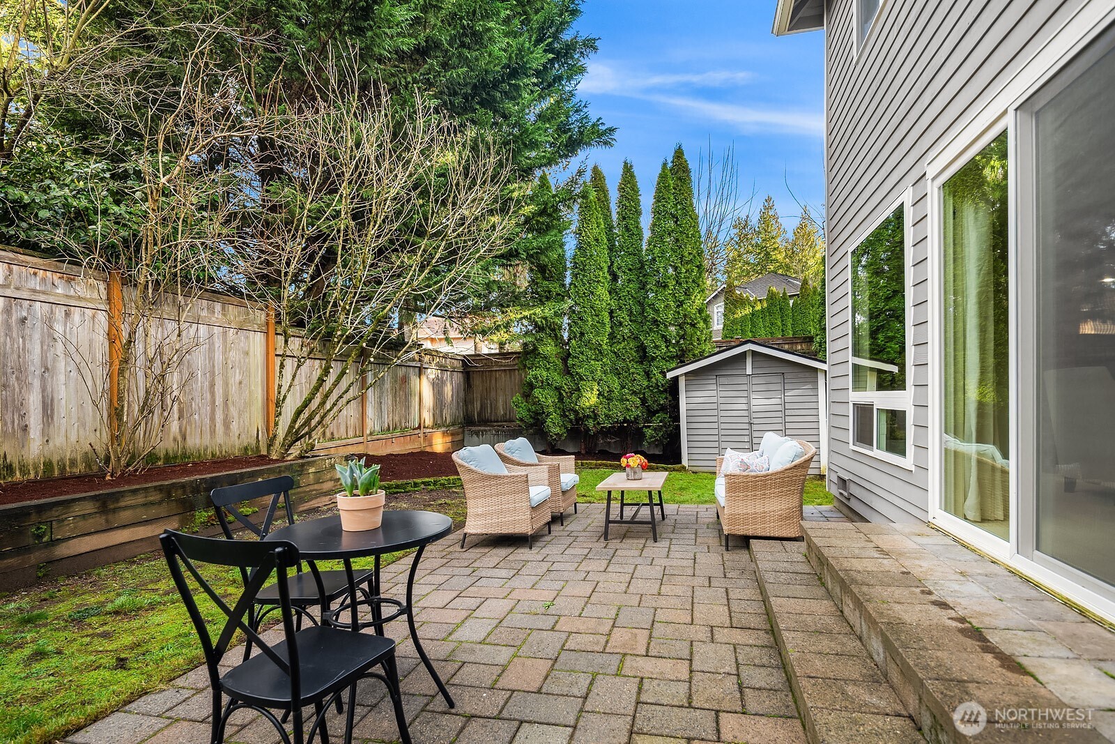 4662 244th Place Southeast Issaquah, WA 98029 - Photo 29 of 40 a view of a patio with a dining table and chairs with wooden floor