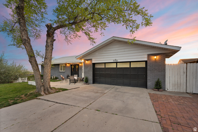9750 Indian Ridge Drive Sandy, UT 84092 - Photo 7 of 40 View of front facade with brick siding, driveway, and a garage