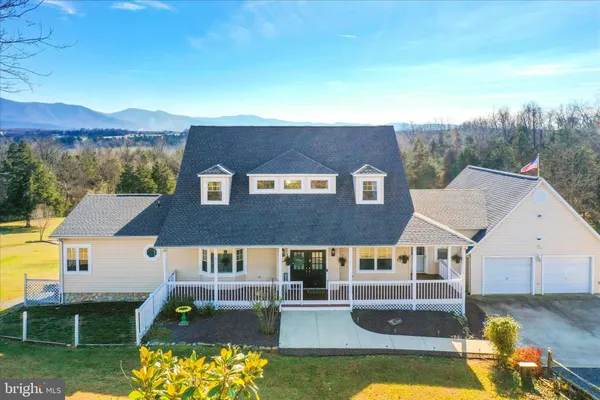 an aerial view of house with yard swimming pool and mountains