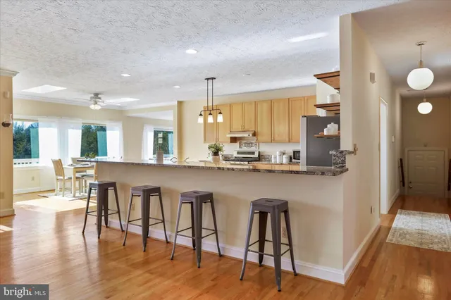 a spacious bedroom with a bed a chandelier and a window