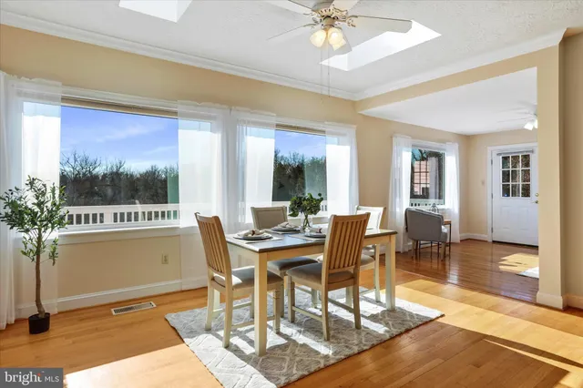 a spacious bedroom with a bed a rug and a chandelier