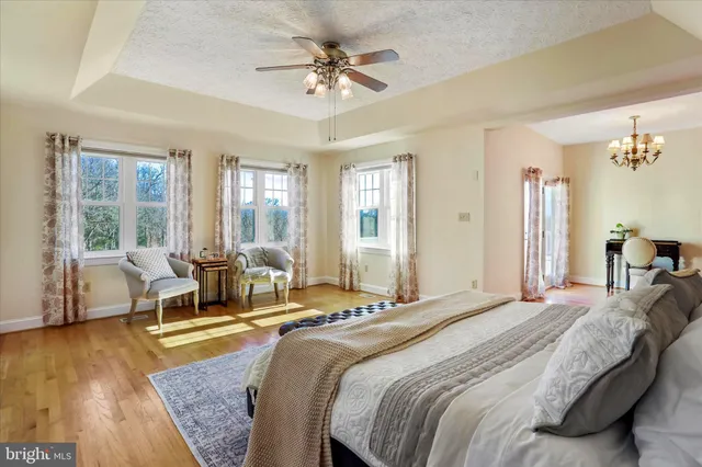 a view of a livingroom with wooden floor and a chandelier