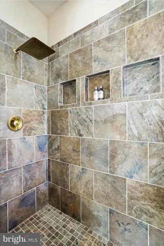 a large kitchen with kitchen island a large counter top space a sink stainless steel appliances and cabinets