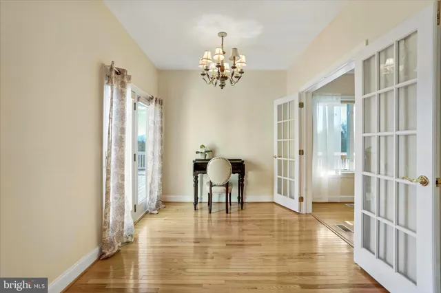 a bedroom with a bed a dresser and book shelf