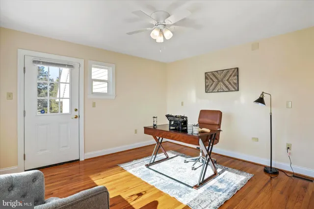 a bedroom with furniture and a large window