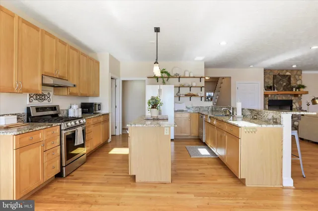 a view of a hallway with wooden floor and windows