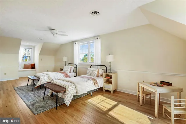 a front view of a house with a garden and yard