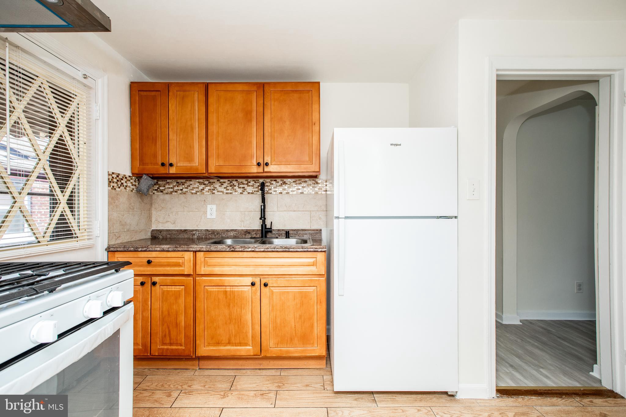 130 Reed Avenue Hamilton, NJ 08610 - Photo 8 of 29 a kitchen with a refrigerator a stove top oven