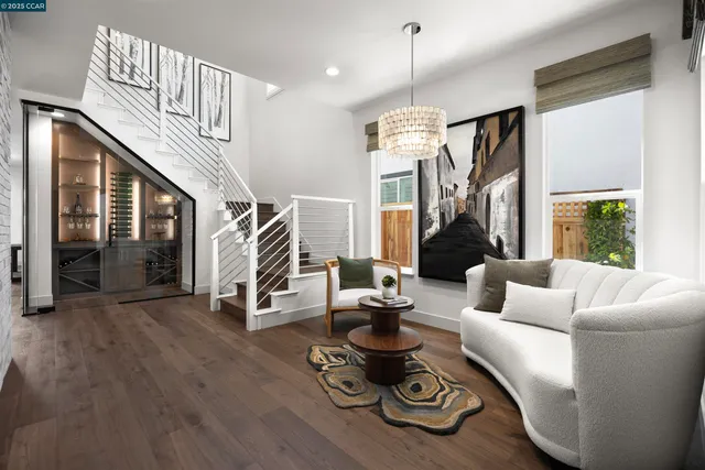a living room with furniture a fireplace and a chandelier