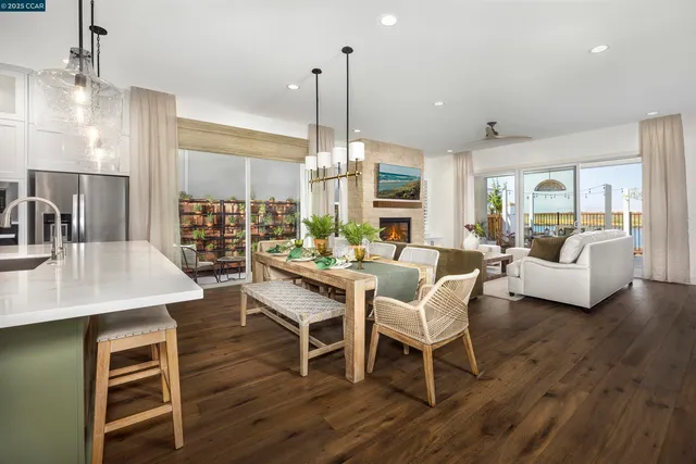 a dining room with furniture a chandelier and wooden floor