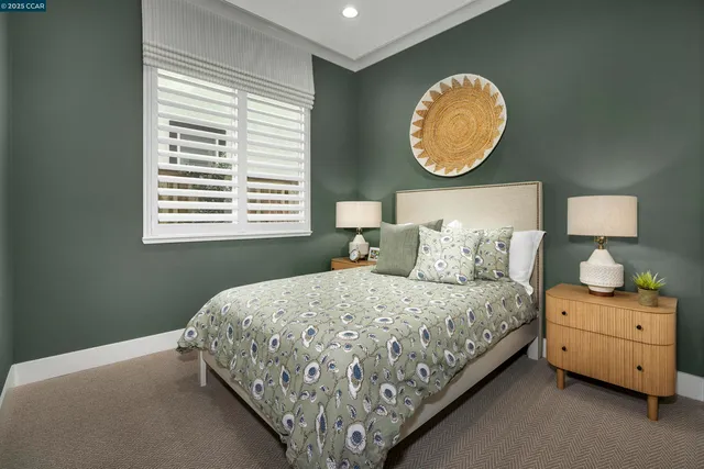 a bed sitting in a bedroom next to a window