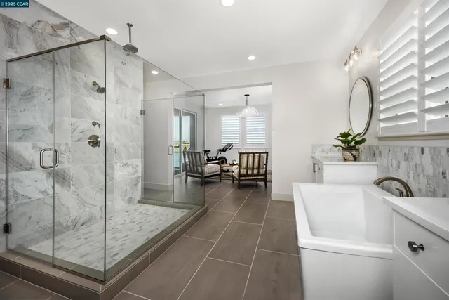 a spacious bathroom with a shower and mirror