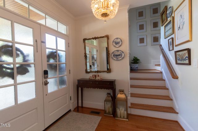 a view of a dining room with furniture and a potted plant