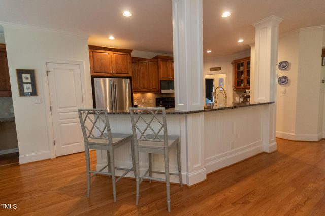 a kitchen with a refrigerator and cabinets