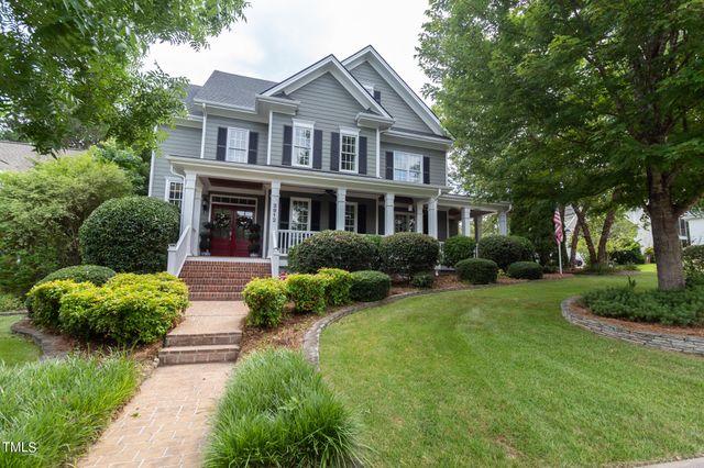 a front view of a house with a garden and plants