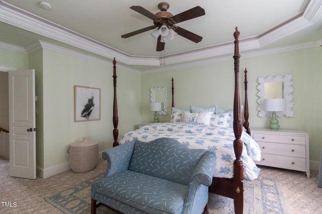 a bedroom with a bed flat screen tv and a couch