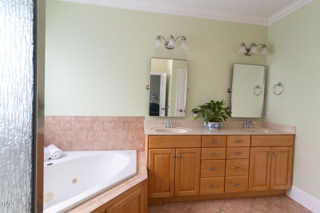 a bathroom with a tub sink and mirror