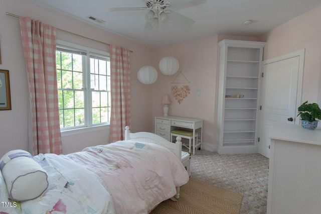 a bedroom with bed couch and window
