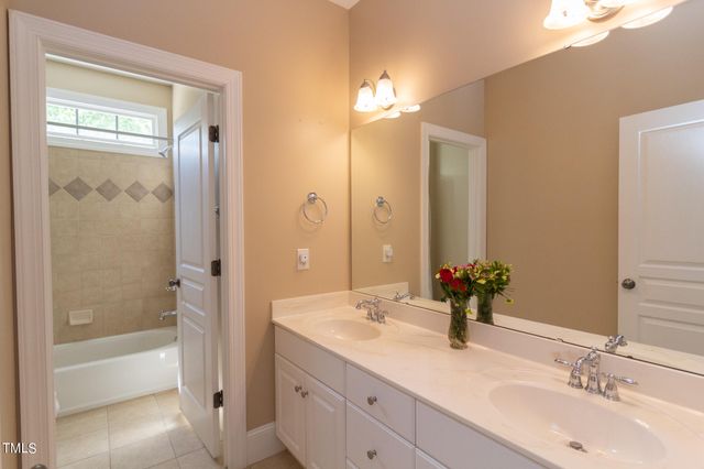 a bedroom with bed and a chandelier
