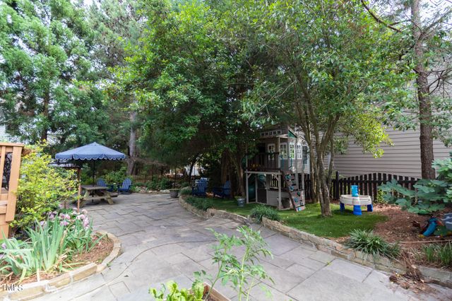 a view of a table and chairs under an umbrella