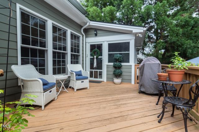 a view of a deck with table and chairs and wooden floor