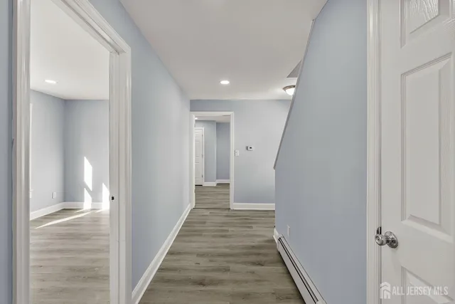 a view of a hallway with wooden floor