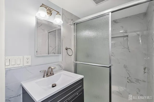 a bathroom with a sink vanity and a mirror