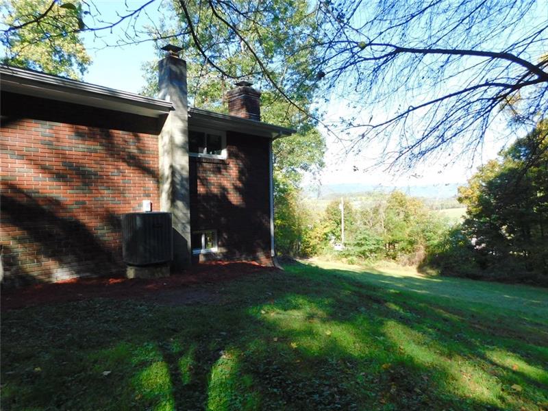 820 Muir Road Ligonier, PA 15658 - Photo 18 of 24 Side of home with mountains in background.