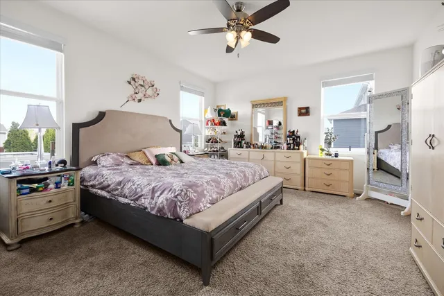 a spacious bedroom with a bed and a chandelier