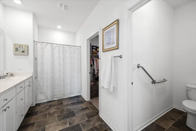 a bathroom with a granite countertop sink toilet and shower